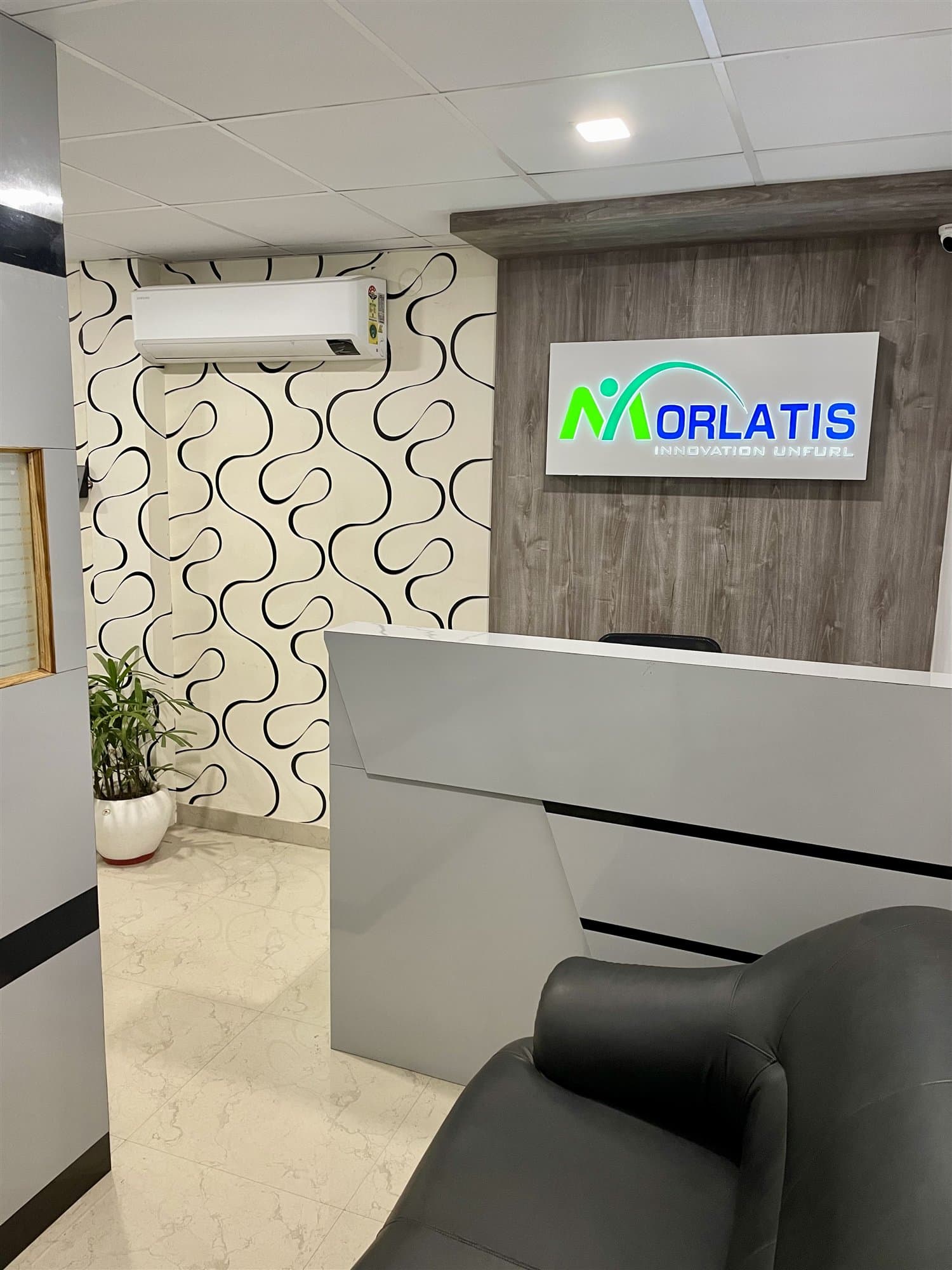 The Morlatis head office reception, with the illuminated company sign behind the desk